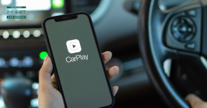 person holding a phone in their car with apple carplay